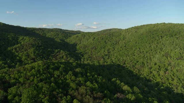 Aerial ascending over North Carolina Appalachian mountains at sunset in spring time near Taylorsville