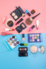 Decorative cosmetics and makeup brushes on a white background on a pink-blue background.