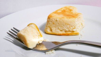 Slice of cheesecake. Fork on a plate
