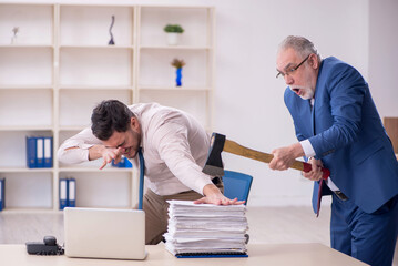 Old male boss and young male employee in bullying concept
