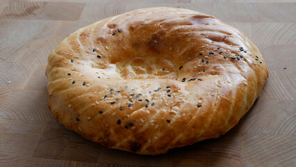 Bread cakes with seeds on a wooden board. Fresh bakery
