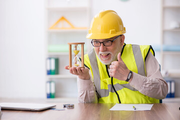 Old male architect in time management concept