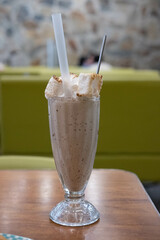 Chocolate Milk Shake with burnt marshmallow on the table, with blurred background