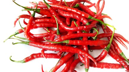 Cabai merah keriting or red hot chili peppers spicy blurred defocus isolated on white background