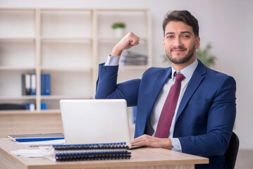 Young male employee working in the office