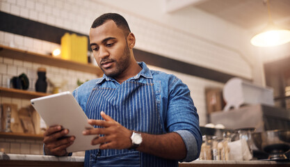 Focus, tablet and manager with man in cafe for online, entrepreneurship and startup. Waiter,...