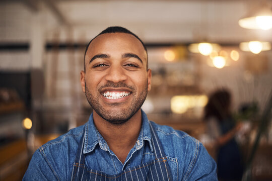 Coffee shop, happy waiter and portrait of black man in restaurant for service, working and smile in cafe. Small business owner, bistro startup and face of male waiter in cafeteria ready to serve