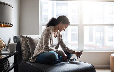 Fototapeta premium Girl, tablet and credit card and ecommerce on couch or online shopping, home and paying for product, retail and internet store. Black woman, banking and money for service, digital payment or goods