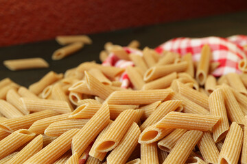 Pile of Uncooked Dried Whole Wheat Penne Rigate Pasta	
