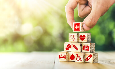 Hand arranged wooden blocks with icons of medical health. health insurance for your health concept....