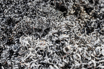A lot of metal shavings close-up, after working on a milling machine or CNC machine. Texture metal shavings. Recycling of waste. Ecology. Saving resources.