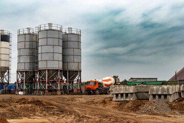 Concrete mixer standing by a modern concrete plant. Production of concrete on an industrial scale. Delivery of concrete to the construction site.
