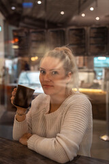 woman drinking coffee in cafe