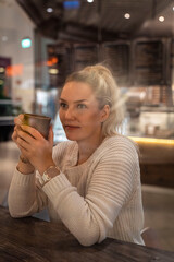 person drinking coffee in cafe