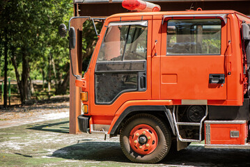 Obraz premium The golden rays of sunlight enhanced the vibrant red color of the fire engine serving as a reminder of the brave firefighters who stand ready to battle the forces of fire and ensure the safety.