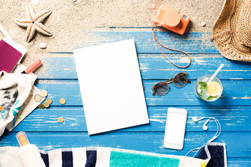 Magazine cover and smartphone mockup on blue wood plank background with summer accessories