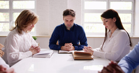 Group Of Young Multiethnic People Reading Bible Over Wooden