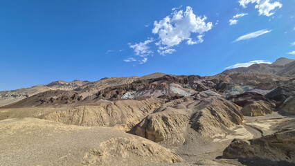 Fototapeta na wymiar Scenic view of colorful geology of multi hued Amargosa Chaos rock formations in Death Valley National Park, Furnace Creek, California, USA. Barren desert landscape of Artist Palette in Black mountains