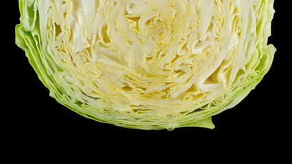 Fresh cabbage isolated on black background. Water dripping down  the cabbage
