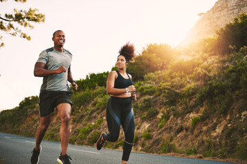 Sports, health and couple running by mountain training for race, marathon or competition. Fitness, nature and African runners doing outdoor cardio workout or exercise on road trail together at sunset