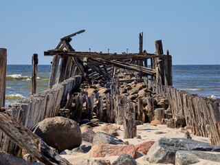 Remains of a wooden sea pier. Sventoi, Lithuania. Selective focus.