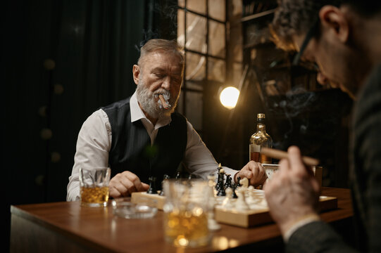 Family Of Intelligent People Playing Chess, Smoking Cigars And Drinking Whiskey