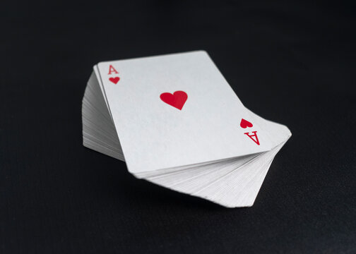 deck of playing cards with ace love on the top on black background