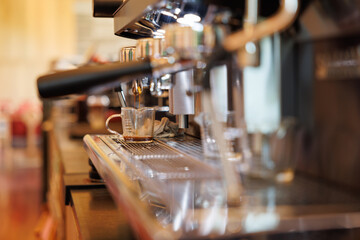 Fototapeta na wymiar coffee machine is pouring the coffee. Coffee machine in steam, barista preparing coffee at cafe.
