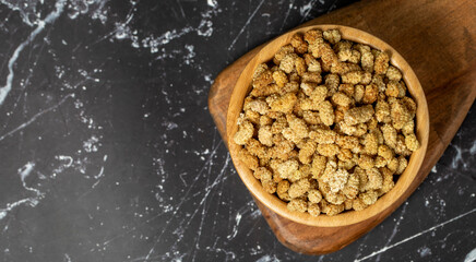 Dried mulberry Sun-dried organic white dried mulberry in wooden bowl. Superfood, Vegetarian food concept. healthy snacks. Top view. Copy space. Empty space for text