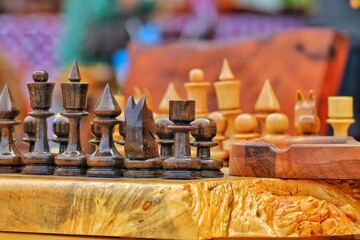 Beautiful photo of chess pieces on the board. Rainbow colored blurred background. Not boring mahogany chess pieces queen and king.