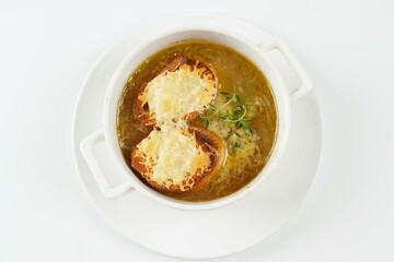 A classic French Onion Soup with with gruyere cheese and toasted baguette in a bowl