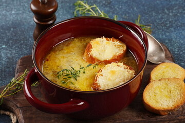 A classic French Onion Soup with with gruyere cheese and toasted baguette in a bowl