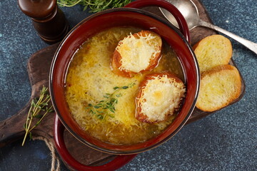 A classic French Onion Soup with with gruyere cheese and toasted baguette in a bowl