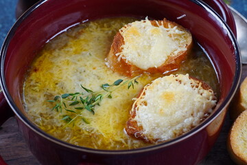 A classic French Onion Soup with with gruyere cheese and toasted baguette in a bowl