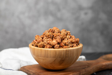 Honey with sesame peanuts. Sesame peanuts in wooden bowl. Superfood, Vegetarian food concept. healthy snacks