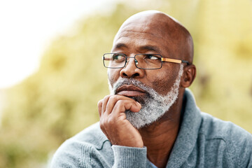 senior, black man and face thinking outdoor in nature to remember memory, idea or vision. Headshot of an elderly male person think or planning future, life insurance or retirement at a park in summer - obrazy, fototapety, plakaty