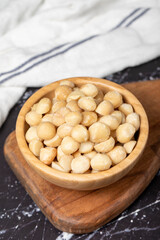 Macadamia Nuts. Macadamia Nuts in wooden bowl. Superfood. Vegetarian food concept. healthy snacks. Close up