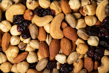 Mixed nuts. Special mixed nuts closeup food background. Top view. Mix hazelnut, almond, cashew, pistachio, dried blueberry. texture. copy space banner