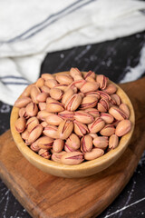 Pistachio nut. Pistachio in shell in wooden bowl. Superfood. Vegetarian food concept. Healthy snacks. Close up