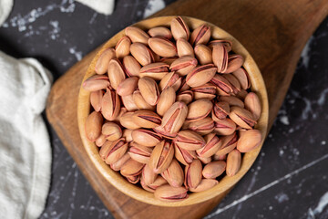 Pistachio nut. Pistachio in shell in wooden bowl. Superfood. Vegetarian food concept. Healthy snacks. Top view