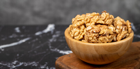 Walnut. Walnut kernel in wooden bowl. Superfood. Vegetarian food concept. Healthy snacks. Copy space. Empty space for text