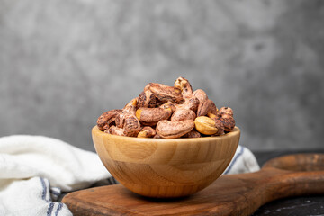 Cashew nuts . Roasted cashew nuts with shell in wooden bowl. Superfood. Vegetarian food concept. Healthy snacks