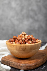 Fototapeta na wymiar Hazelnut. Peeled hazelnuts in wooden bowl. Superfood. Vegetarian food concept. Healthy snacks