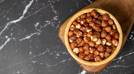 Hazelnut. Peeled hazelnuts in wooden bowl. Superfood. Vegetarian food concept. Healthy snacks. Top view. Copy space. Empty space for text