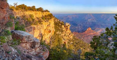 The last rays of the setting sun illuminate the majestic Grand Canyon.