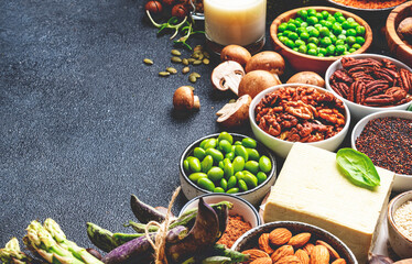 Vegan protein. Plant based vegetarian food sources. Healthy eating, diet ingredients: legumes, beans, nuts, alternative milk, tofu, vegetables, seeds and sprouts. Food background. Top view