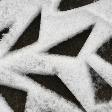 triangular foot steps in white snow