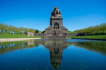 LEIPZIG, GERMANY April, 2023: The gigantic monument Battle of the Nations in Leipzig with artificial lake in front and tall statues inside