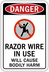Fototapeta premium Barbed and razor wire warning sign and labels razor wire in use, will cause bodily harm