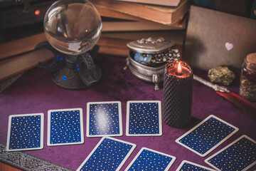 Tarot cards and candles, witch magic bottles . Wicca, esoteric, divination and occult background with vintage magic objects for mystic rituals